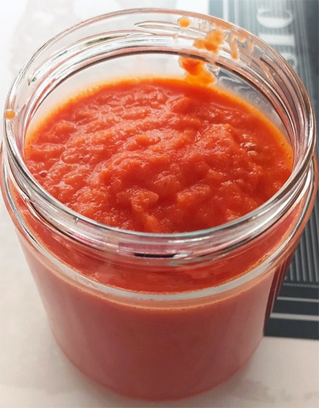 tomato sauce with onions in a glass jar