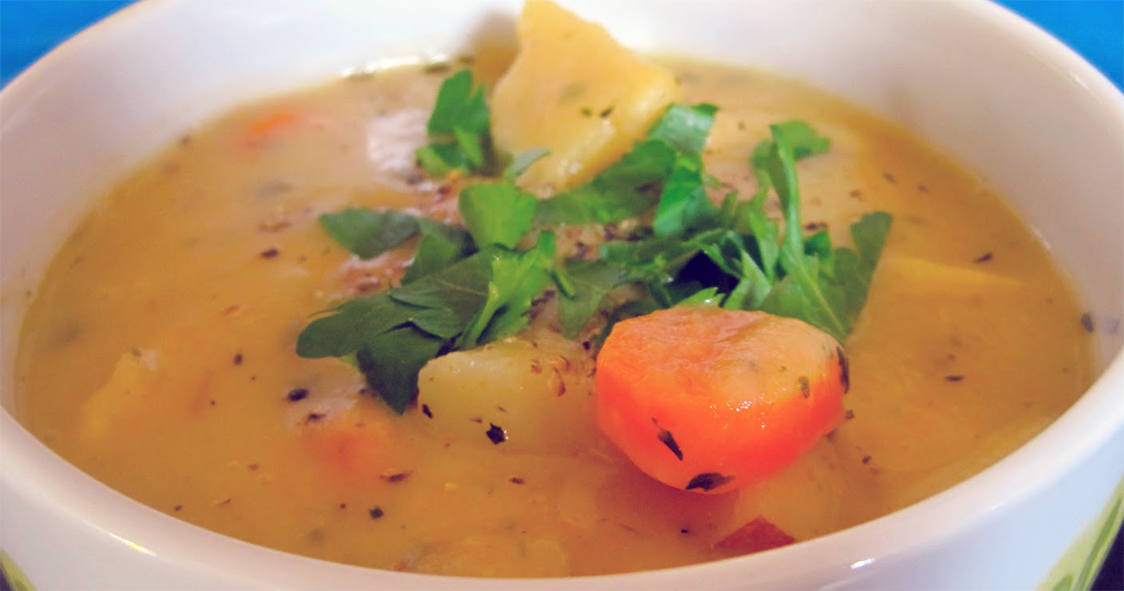 carrot, parsnip and potato soup thickened with roux served garnished with watercress