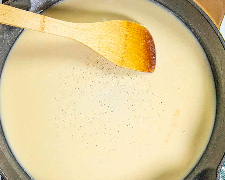 white roux in a pan with a spatula