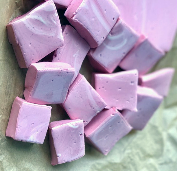 home-made beetroot marshmallow squares on parchment paper