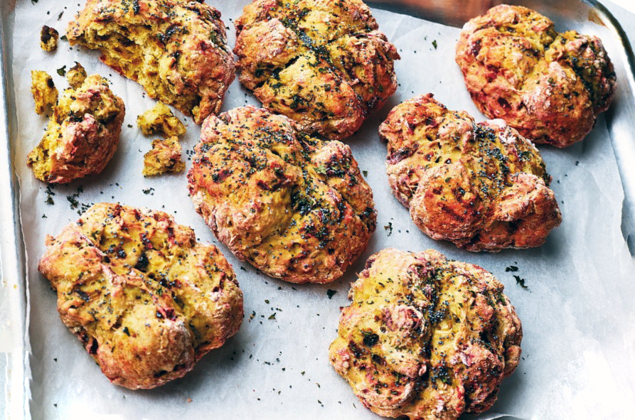 mini soda bread rolls containing beetroot and mint on a baking paper lined roasting tin