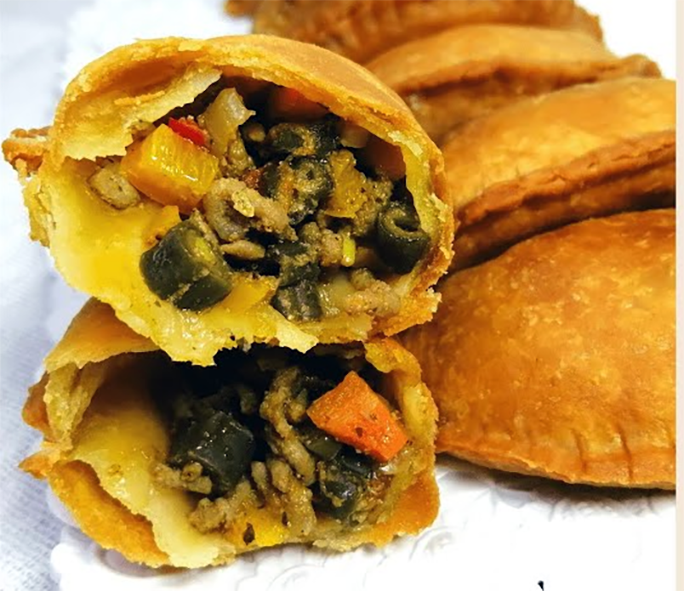 Cameroonian filled and deep fried pastries shown split to reveal the filling