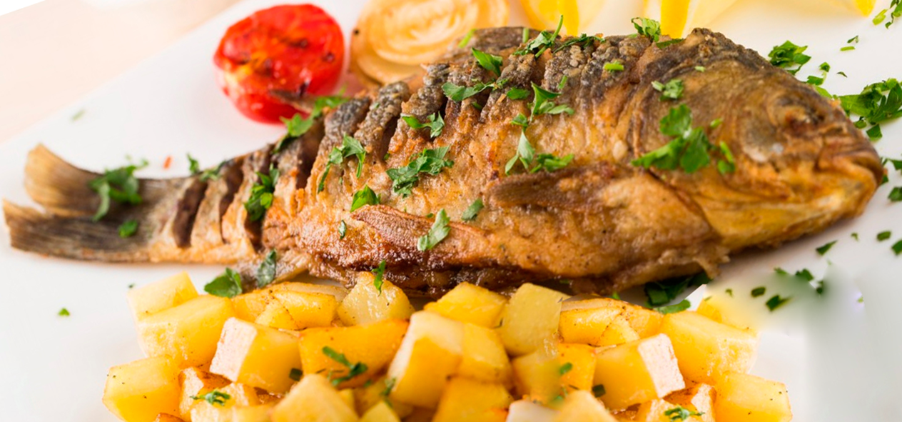 baked bream served with the potatoes on which it was baked