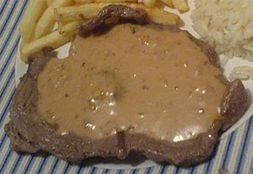 thin beef steak topped with peanut sauce served with fried and rice