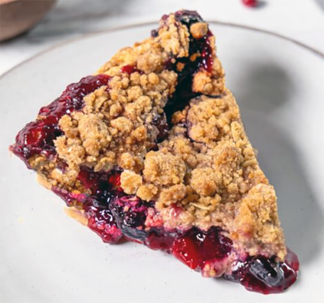 slice of bilberry and cowberry pie with ground almond, egg and icing sugar topping