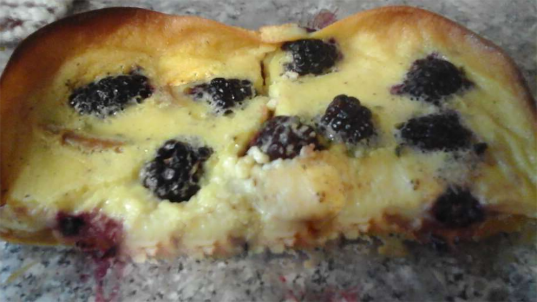 two pieces of blackberry flognarde on a granite work top