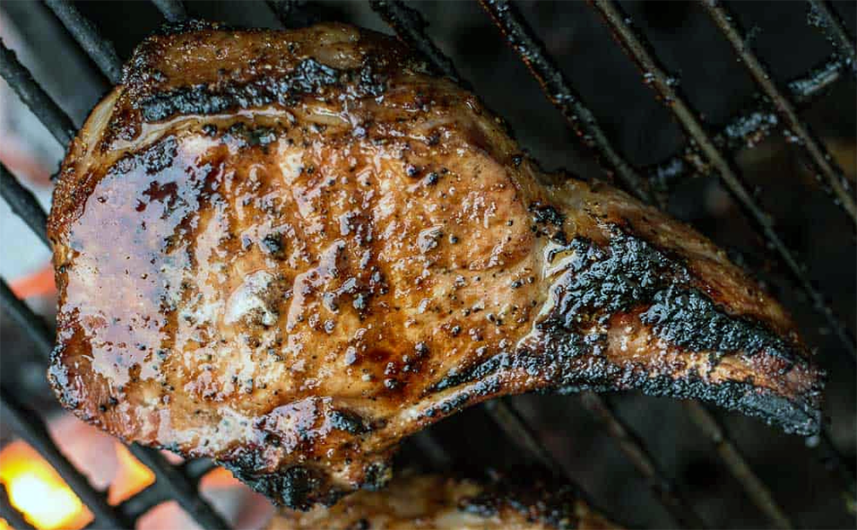 blackened pork chop on a barbecue