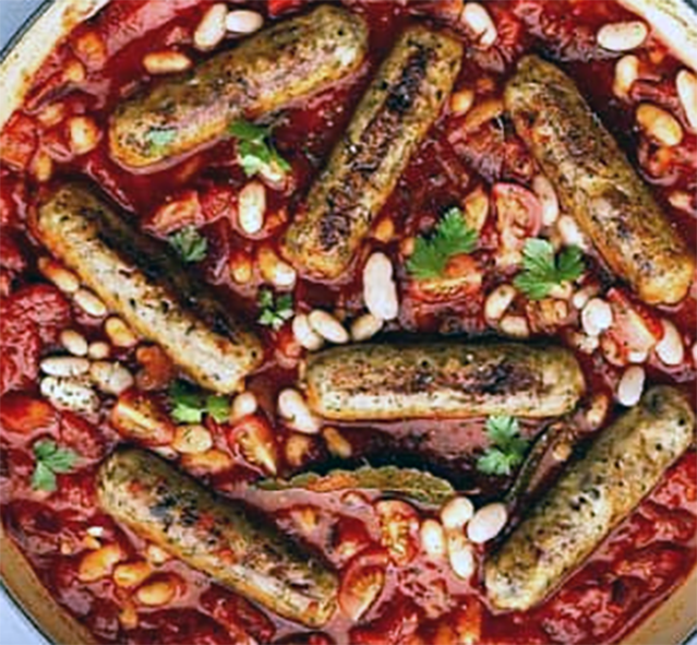 cannellini bean stew in tomato sauce topped with roasted sausages