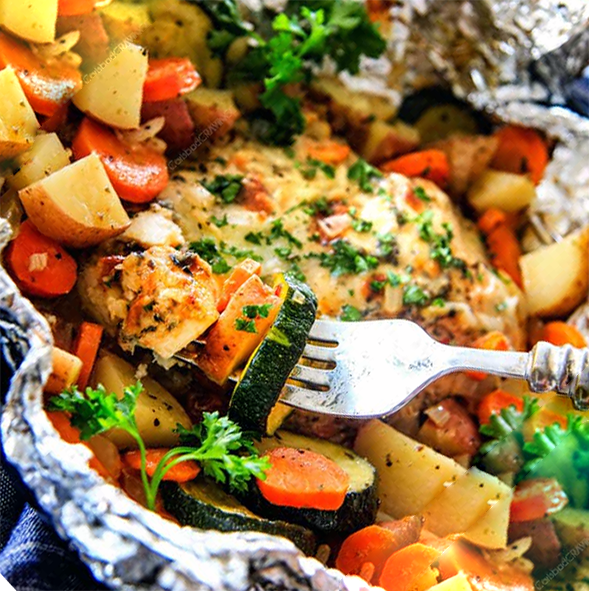 chicken breast and mixed vegetables cooked in a kitchen foil parcel