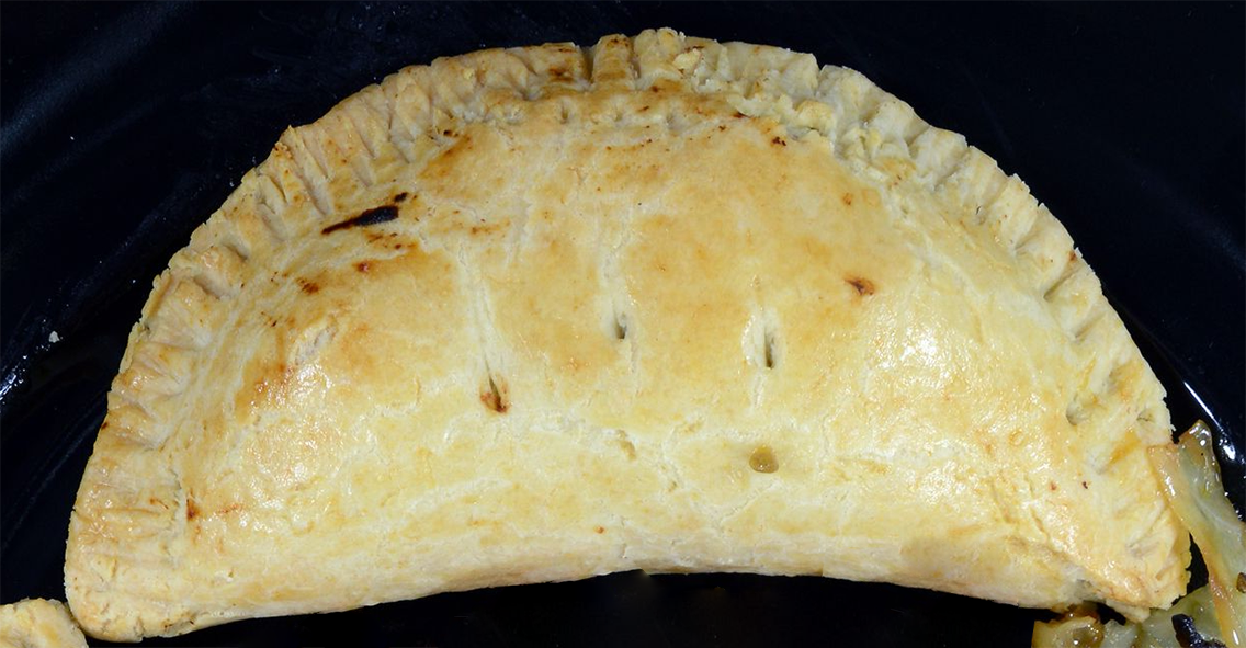 Botswanan chicken pie on a black plate