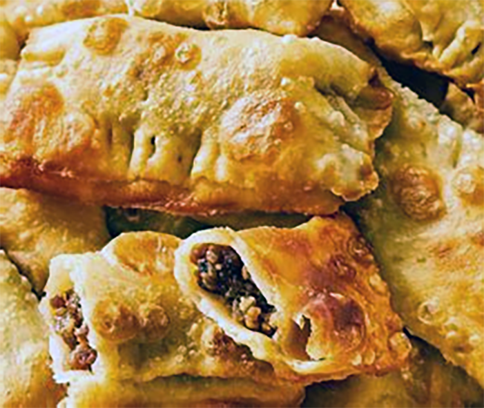 oil pastry pies with lamb and cheese filling arranged on a plate