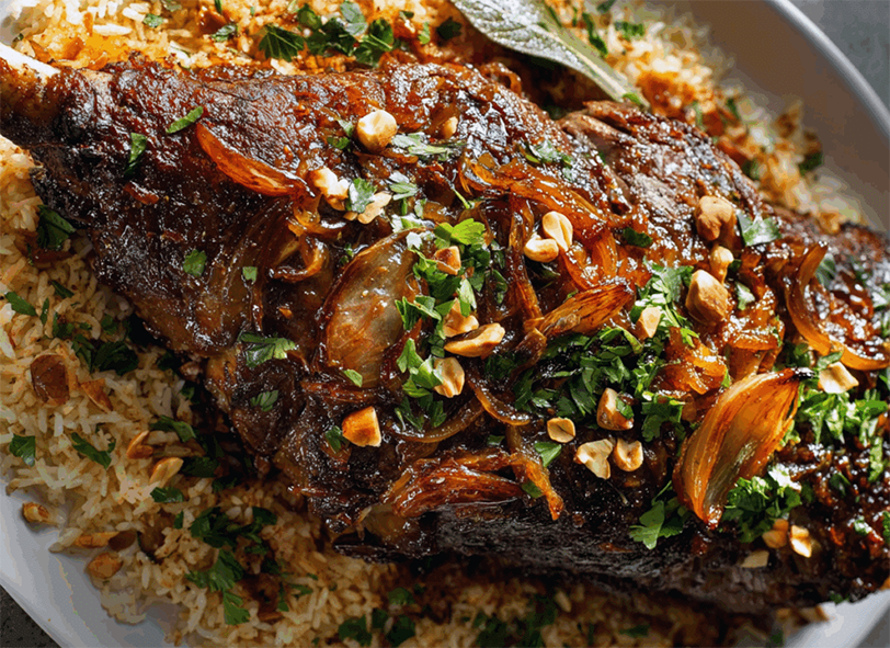 spiced leg of lamb roasted with onions and mushrooms served on a bed of rice