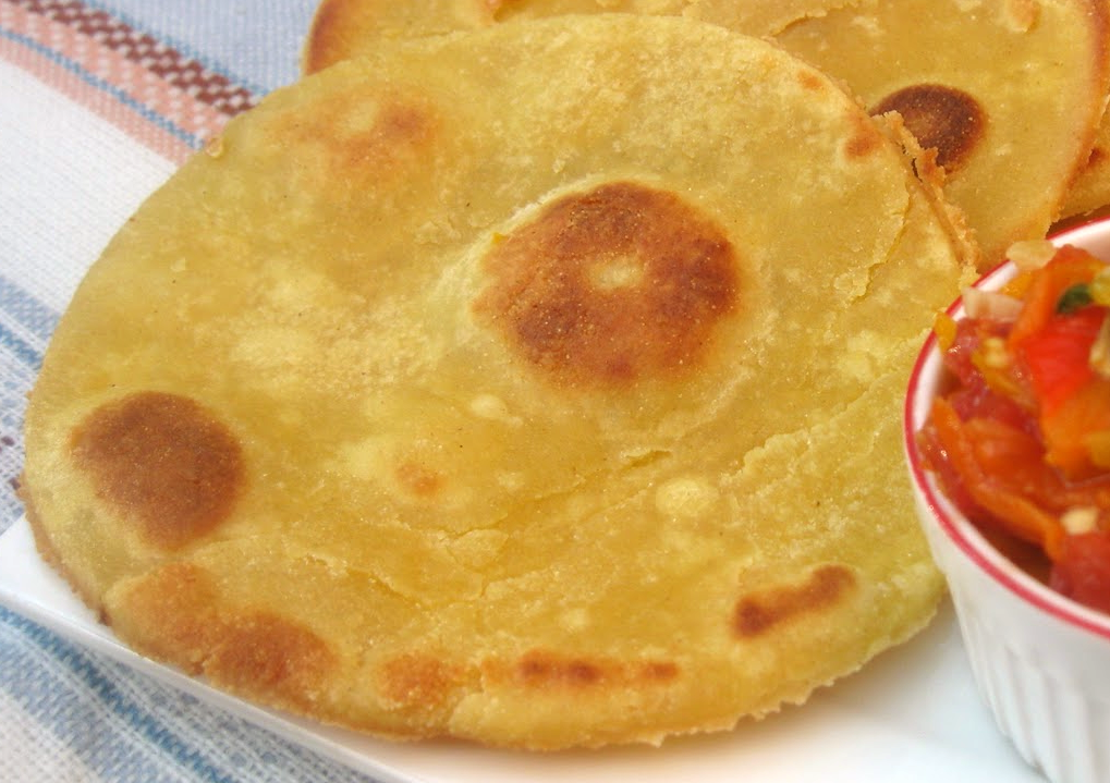 bouzgene, berber flatbread served with a tomato dip