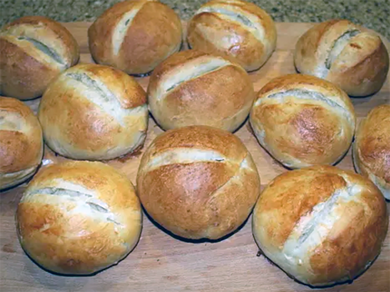 german crusty brotchen bread rolls cooling on a wooden chopping board
