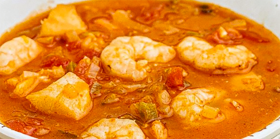 Cape Verdean stew of prawns, green bananas and cassava in a tomato base served in a bowl
