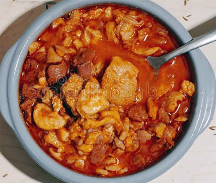 tripe and chorizo in a wine and tomato sauce served in a bowl