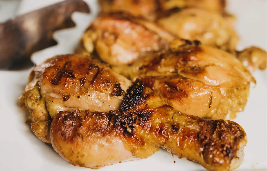 Cameroon-style barbecue chicken thighs on a white plate