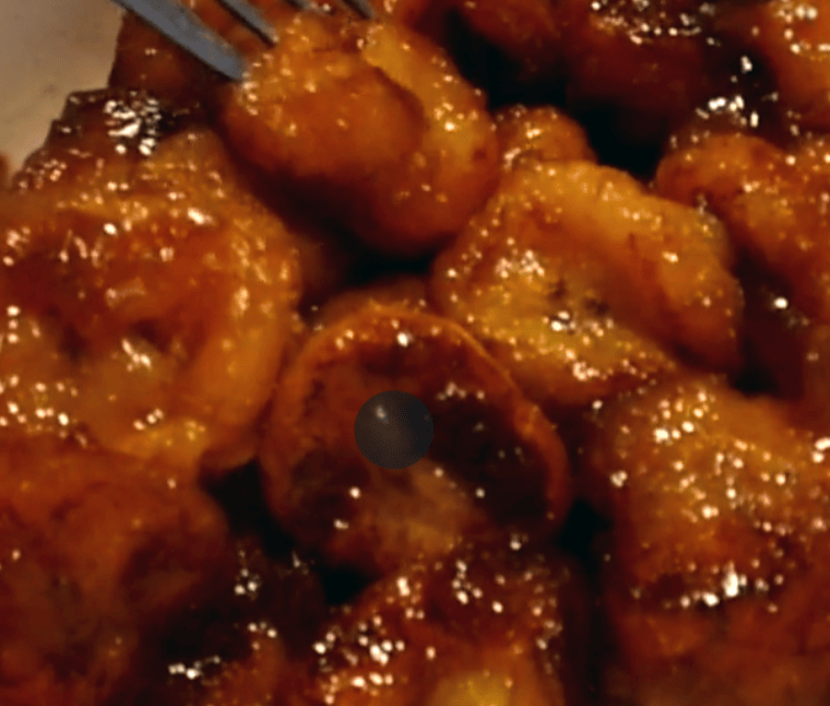 glossy candied plantains with raisins in a bowl