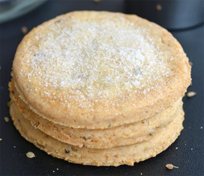 stack of three caraway biscuits dusted with icing sugar