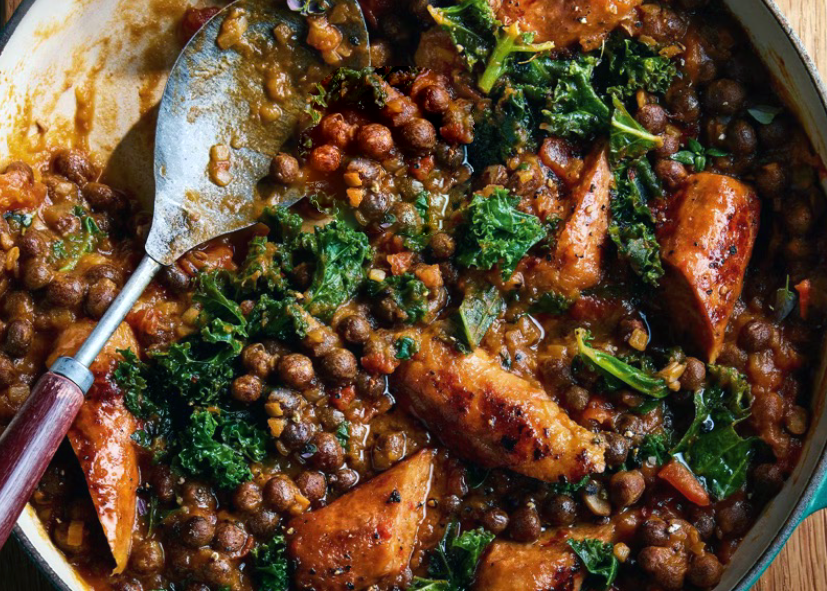 stew of carlin peas, kale and chorizo sausages in a cast iron casserole dish