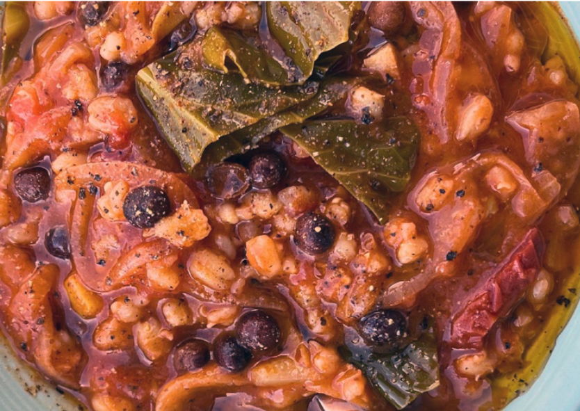 stew of carlin peas, pearl barley and tomatoes with cabbage leaves in a serving bowl