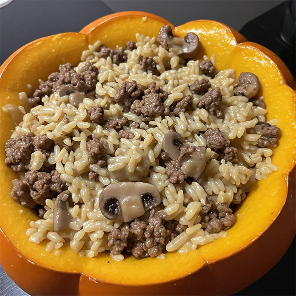 ground beef, mushroom, rice and water chestnut casserole in cream of chicken soup baked in a hollowed out pumpkin