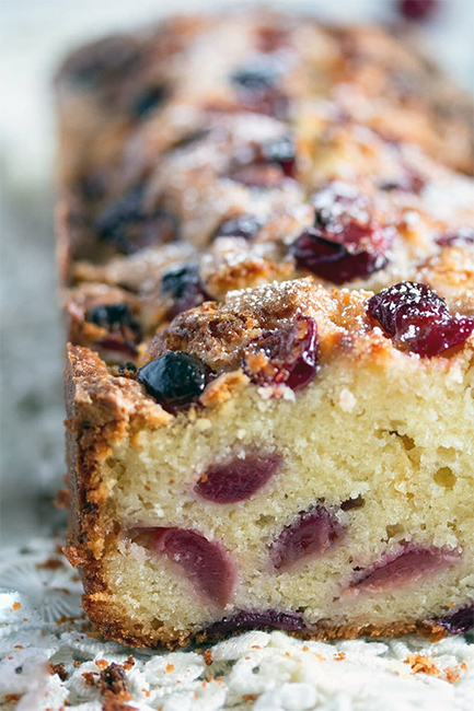log-shaped Irish cherry dog cake with front sliced off to reveal the filling