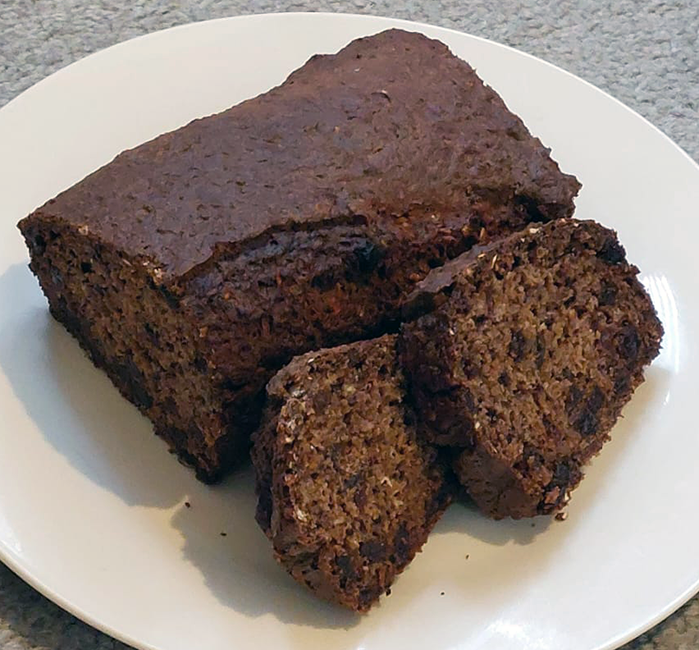 Two slices of chestnut banana cake on the side of the main cake