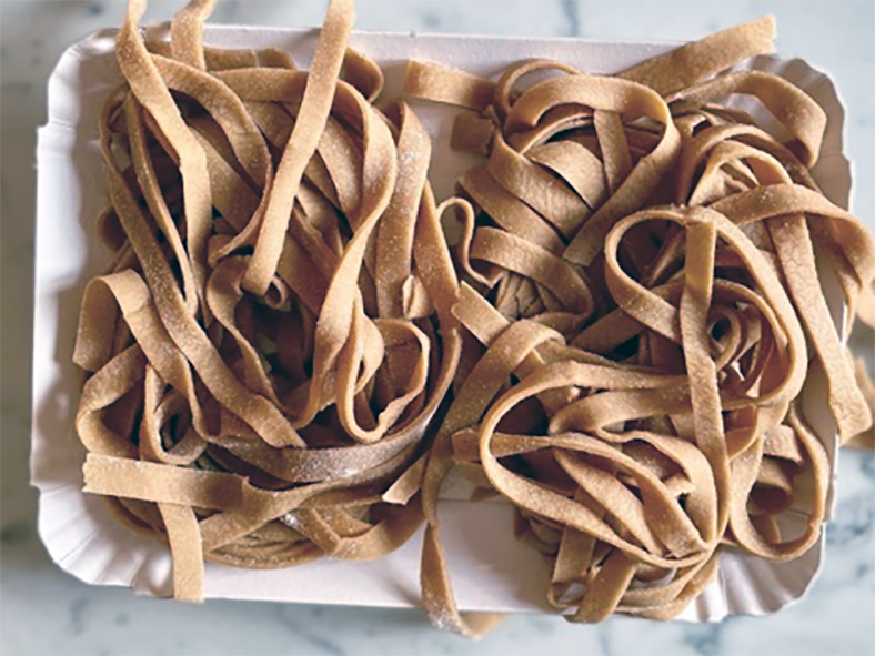 chestnut flour tagliatelle on a white chopping board