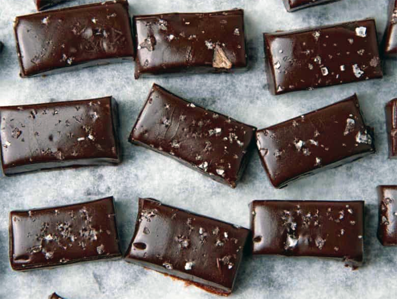 chewy chocolate caramels arranged on greaseproof paper
