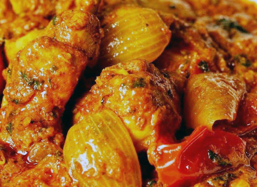 dopiaza curry with chicken pieces and onions on a plate