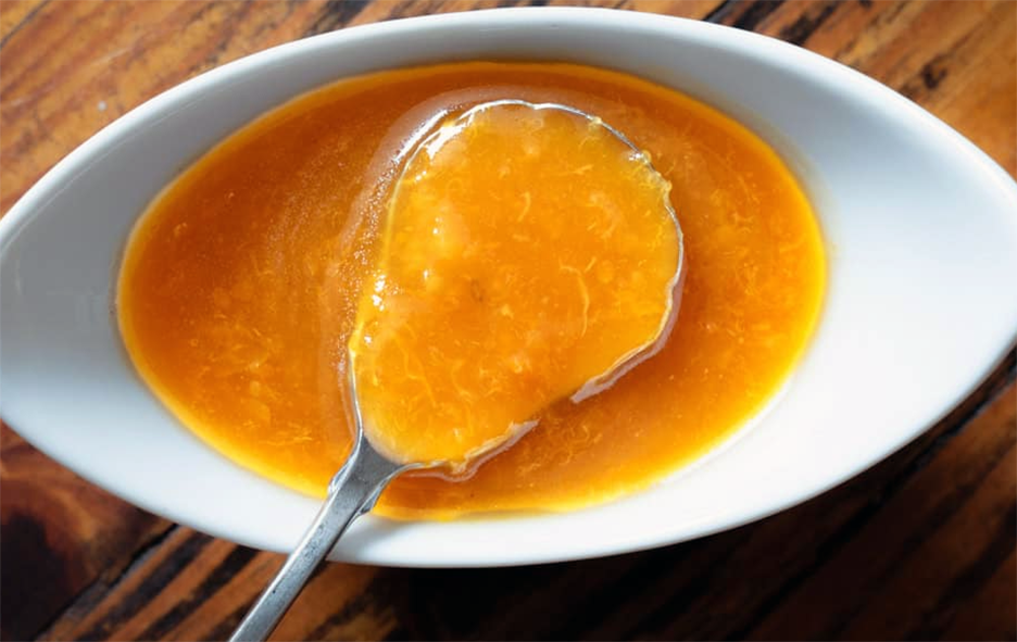 Chinese duck sauce in an oval dish with a spoon
