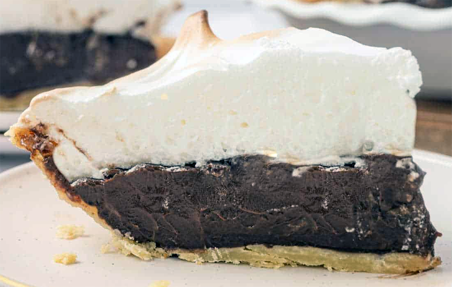 wedge of chocolate meringue pie on a plate