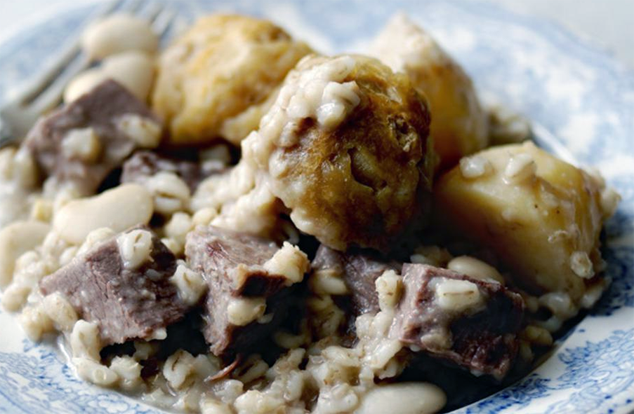 cholent of beans, barley, potatoes and beef served on a plate