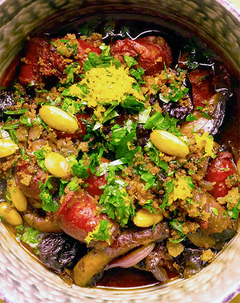 chorizo, prune and almond stew served in a basket topped with pangratto and pine nuts