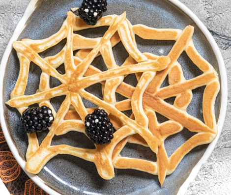 halloween fried batter spider webs on a plate