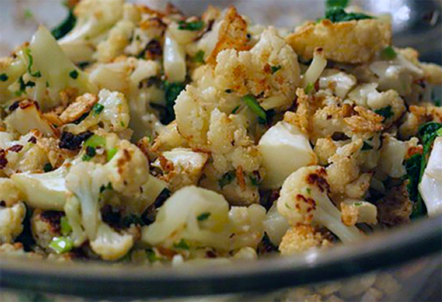 Coliflor salteado served in glass bowl