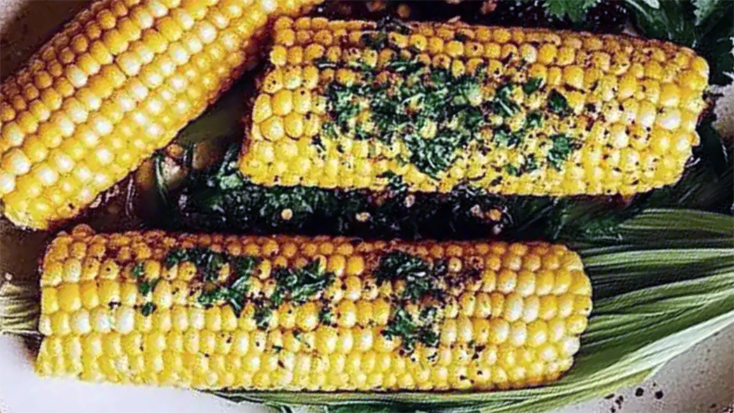 corn on the cob topped with herbed garlic butter