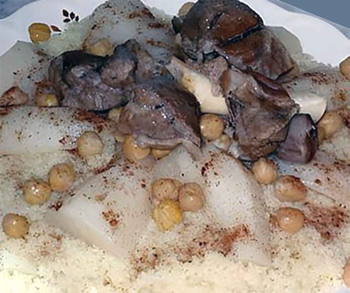 veal and chickpea stew in white sauce served on a bed of white barley couscous