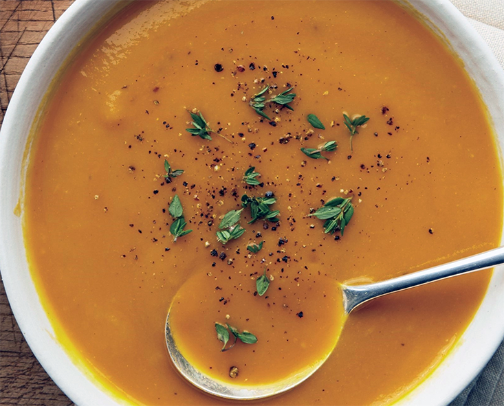 cream of vegetable soup in a bowl garnished with chopped parsley