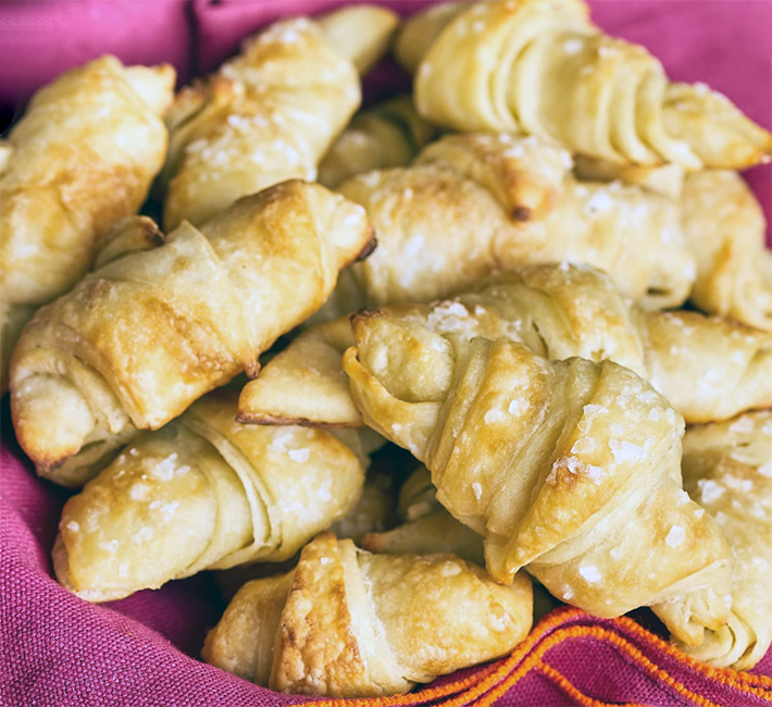 crescent rolls in a bowl lined with a napkin