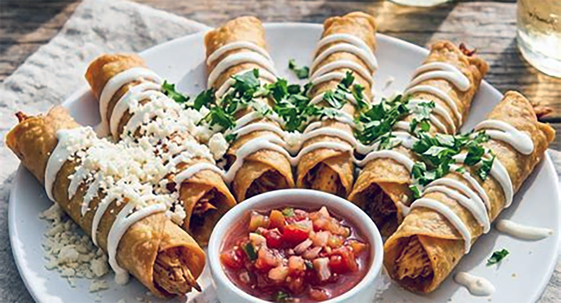 crispy flautas fanned above a bowl of salsa