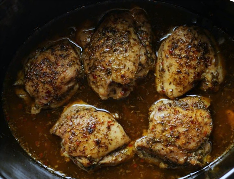 jerk chicken thighs in the base of a slow cooker