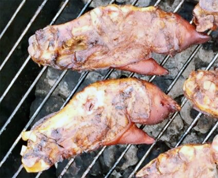 pig trotters cooking on a barbecue