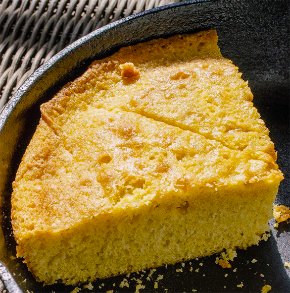 two slices of Mozambican wheat flour and cornmeal cake in a metal baking dish