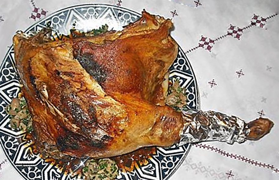 shoulder of lamb stuffed with dates and couscous arranged on a plate