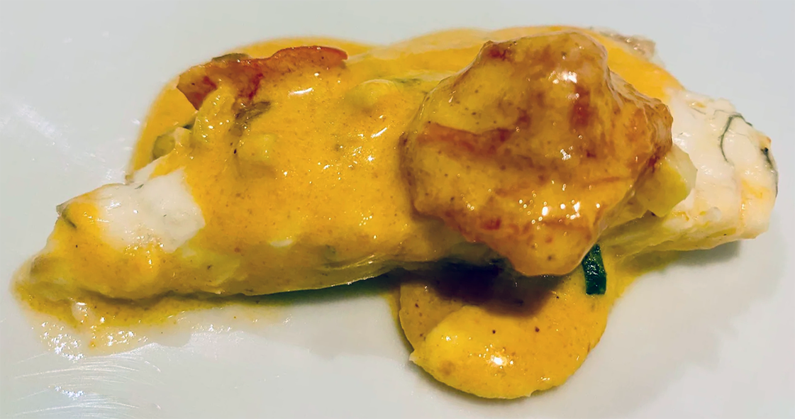 gilt-head bream fillet in coconut sauce with plantain served on a plate