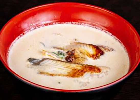 creamy eel soup in a red bowl