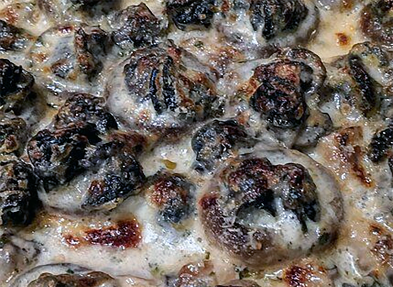 escargot and mushrooms served in a garlic sauce