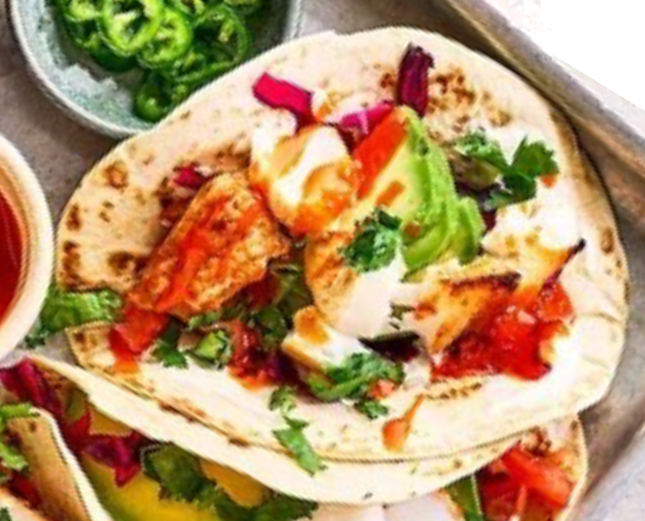 fish taco with avocado and bell pepper on a metal serving tray